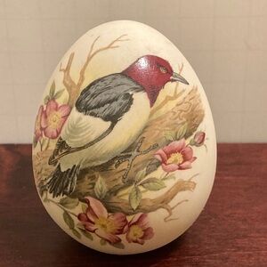 Vintage bisque egg featuring red headed woodpecker resting among flowers